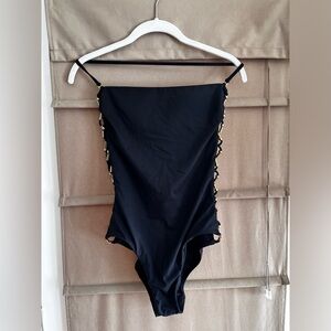 Trina Turk one piece bathing suit, optional strapless with gold side details.